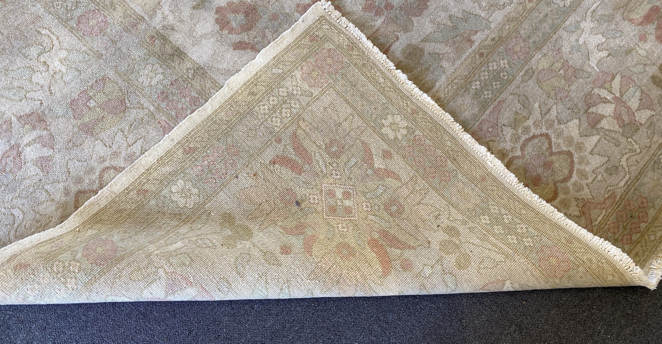 A large Indian ivory ground carpet, 445 x 372cm